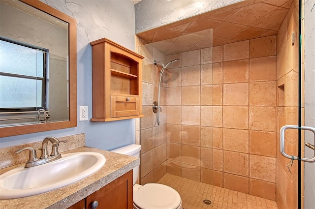 bathroom featuring toilet, walk in shower, and vanity