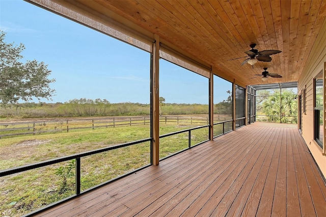 wooden deck featuring ceiling fan and a rural view