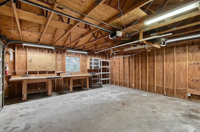 miscellaneous room featuring concrete flooring and a workshop area