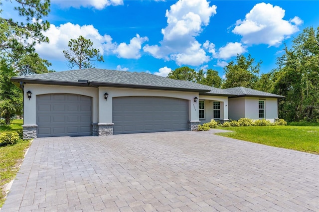 view of front of home with a front yard and a garage