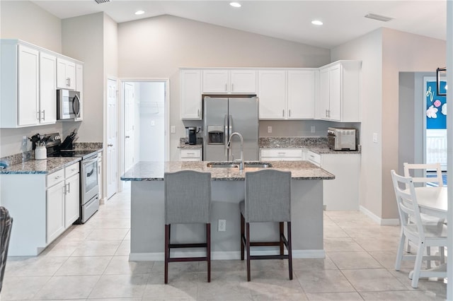 kitchen with white cabinets, an island with sink, and appliances with stainless steel finishes