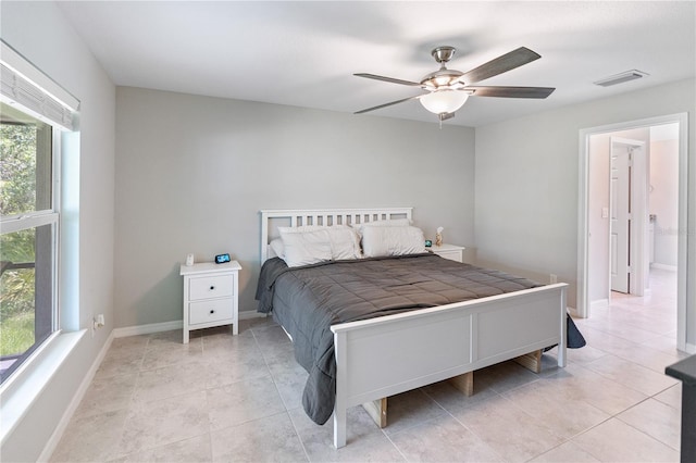 bedroom with ceiling fan and light tile patterned floors