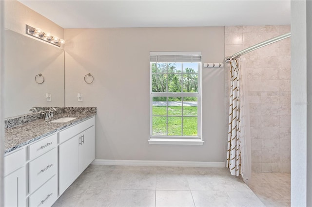 bathroom with a shower with curtain, plenty of natural light, tile patterned floors, and vanity