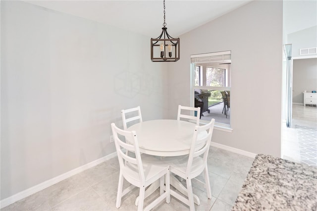 dining area featuring a notable chandelier, vaulted ceiling, and light tile patterned flooring