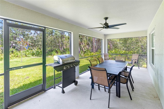 sunroom featuring ceiling fan and a wealth of natural light