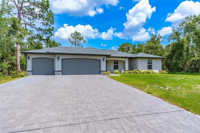 view of front of house with a front yard and a garage