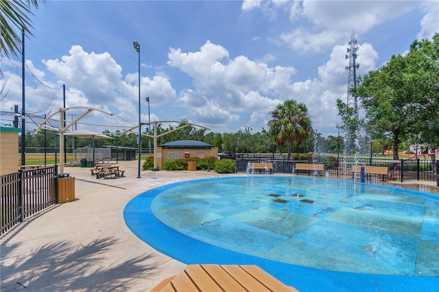 view of swimming pool with pool water feature