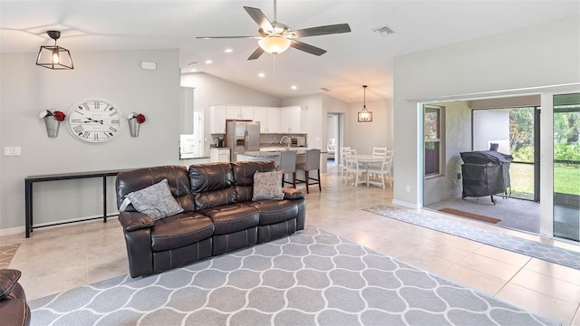 tiled living room featuring vaulted ceiling and ceiling fan