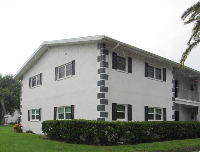 view of property exterior featuring a lawn