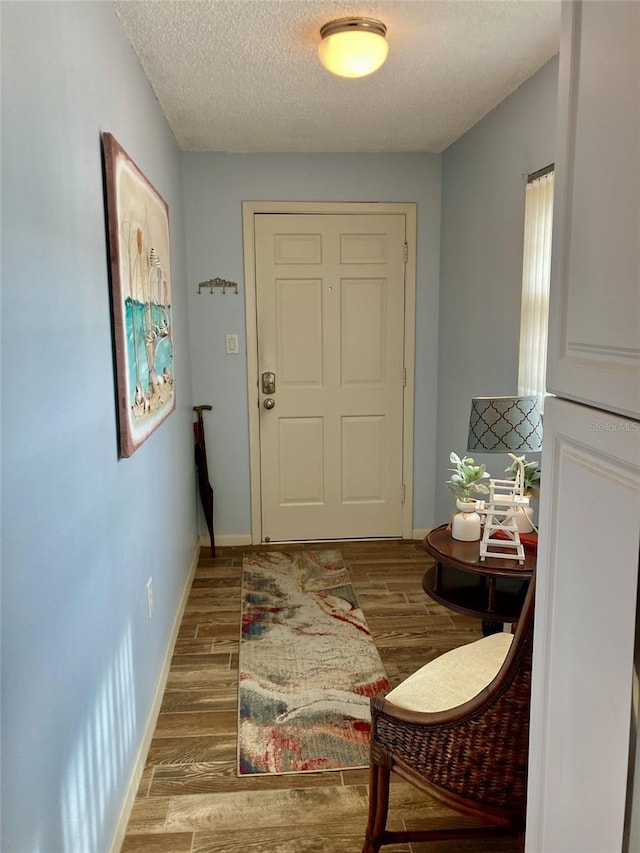 entryway featuring a textured ceiling and hardwood / wood-style flooring