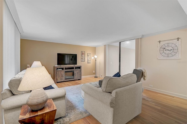 living room with crown molding and light wood-type flooring