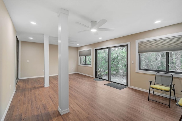 interior space with recessed lighting, decorative columns, baseboards, and wood finished floors