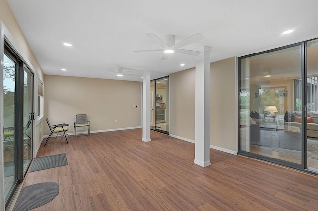 interior space with recessed lighting, baseboards, wood finished floors, and a ceiling fan