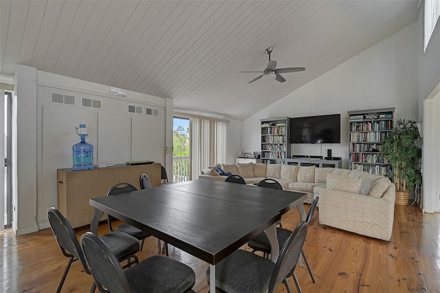 dining area with light hardwood / wood-style floors, wooden ceiling, ceiling fan, and vaulted ceiling