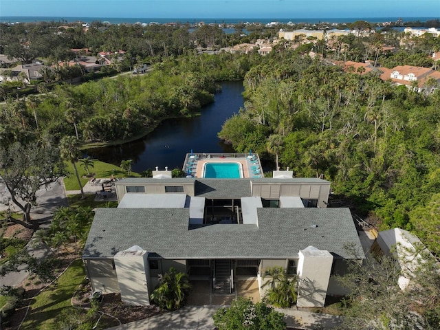 bird's eye view with a forest view and a water view