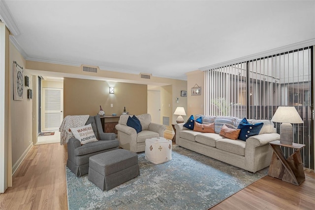 living room featuring hardwood / wood-style flooring and ornamental molding