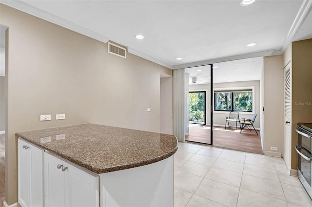 304 Pine Run Dr, Osprey, FL 34229 - kitchen with ornamental molding, recessed lighting, white cabinetry, a peninsula, and double oven range