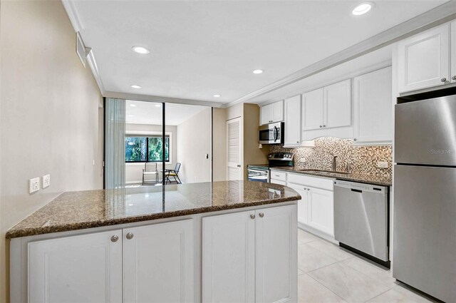 304 Pine Run Dr, Osprey, FL 34229 - kitchen with stainless steel appliances, a sink, white cabinetry, dark stone counters, and recessed lighting