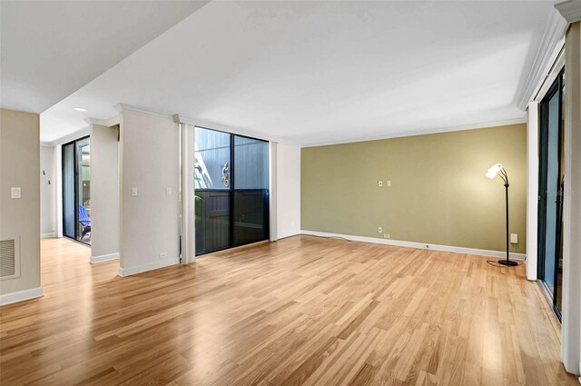 304 Pine Run Dr, Osprey, FL 34229 - empty room with light wood-style floors, baseboards, and crown molding