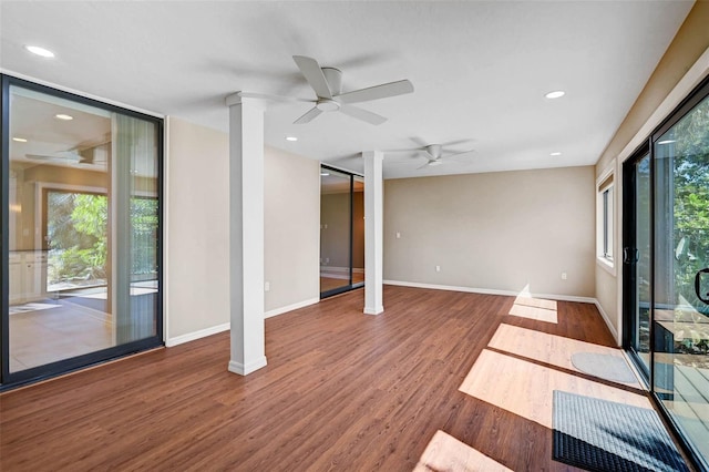 304 Pine Run Dr, Osprey, FL 34229 - unfurnished living room featuring healthy amount of natural light, wood finished floors, ceiling fan, baseboards, and recessed lighting
