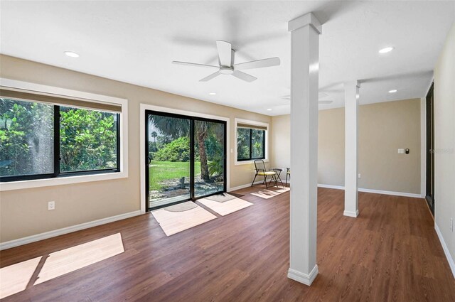 304 Pine Run Dr, Osprey, FL 34229 - unfurnished living room with decorative columns, healthy amount of natural light, wood finished floors, ceiling fan, and recessed lighting