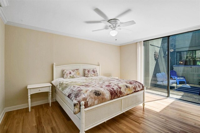 304 Pine Run Dr, Osprey, FL 34229 - bedroom featuring access to outside, wood finished floors, ornamental molding, baseboards, and a wall of windows