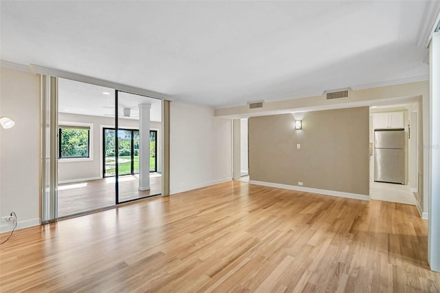 304 Pine Run Dr, Osprey, FL 34229 - unfurnished room with light wood-type flooring, baseboards, decorative columns, and crown molding
