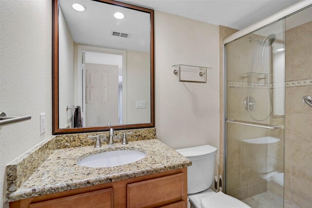 304 Pine Run Dr, Osprey, FL 34229 - full bathroom featuring a stall shower, toilet, vanity, and recessed lighting