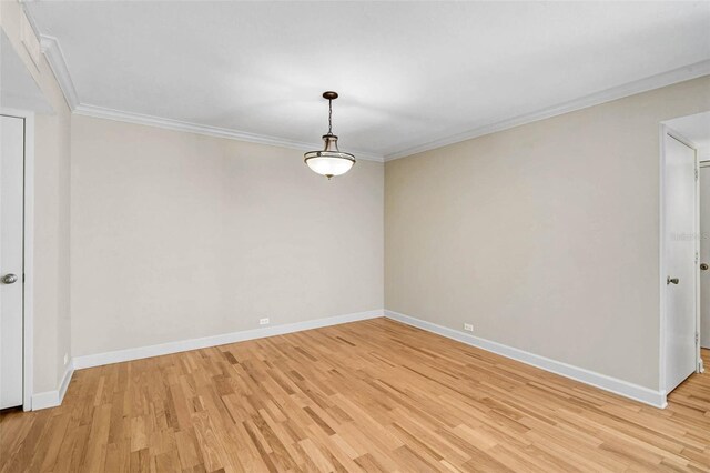 304 Pine Run Dr, Osprey, FL 34229 - empty room featuring light wood finished floors, baseboards, and crown molding