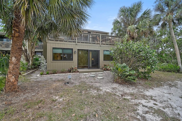 304 Pine Run Dr, Osprey, FL 34229 - back of house with a balcony