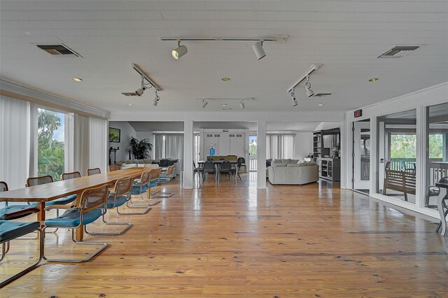 304 Pine Run Dr, Osprey, FL 34229 - dining area with plenty of natural light, rail lighting, and wood finished floors