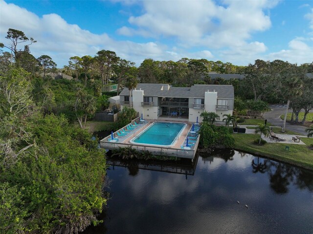 304 Pine Run Dr, Osprey, FL 34229 - back of property featuring stucco siding, view of scattered trees, a water view, and a patio
