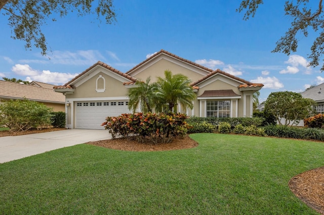 mediterranean / spanish-style house featuring a front yard and a garage