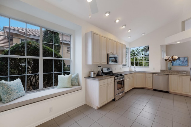 kitchen featuring sink, a wealth of natural light, appliances with stainless steel finishes, and light tile patterned flooring