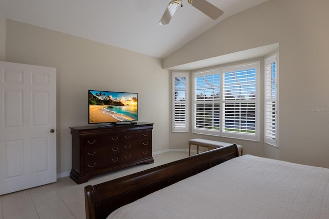 bedroom featuring ceiling fan, light tile patterned floors, and vaulted ceiling