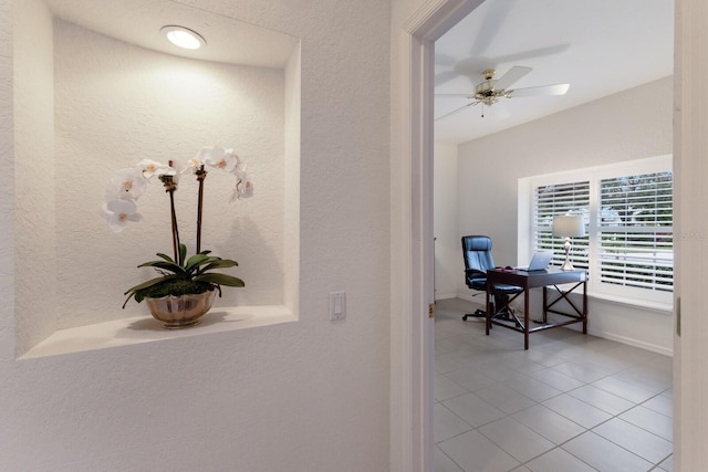 interior space with ceiling fan