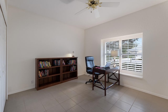 tiled home office featuring ceiling fan