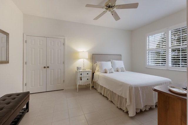 bedroom featuring ceiling fan, a closet, and light tile patterned flooring