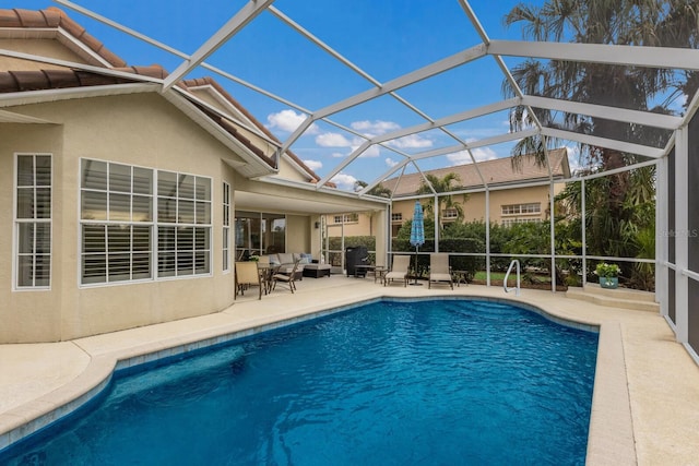 view of pool with an outdoor living space, a patio area, and glass enclosure