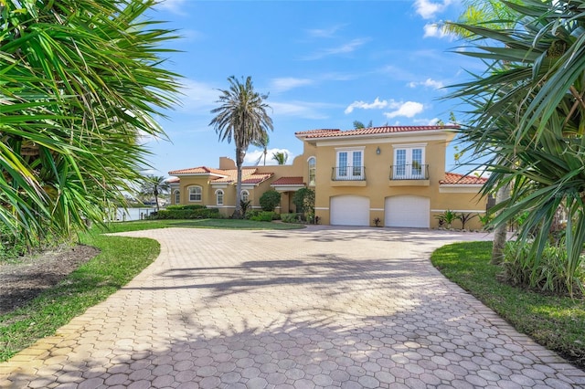 mediterranean / spanish home featuring a garage