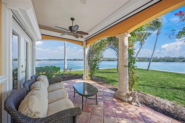 view of patio featuring a water view, ceiling fan, and french doors