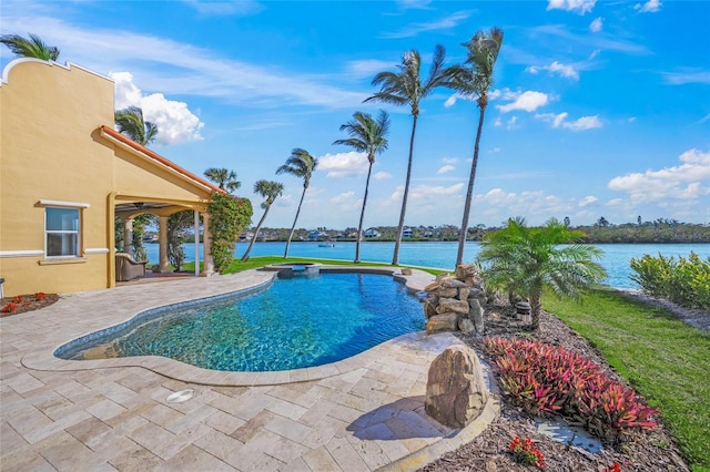 view of swimming pool featuring a water view and a patio