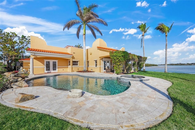 view of swimming pool with a patio area, a water view, french doors, and an in ground hot tub