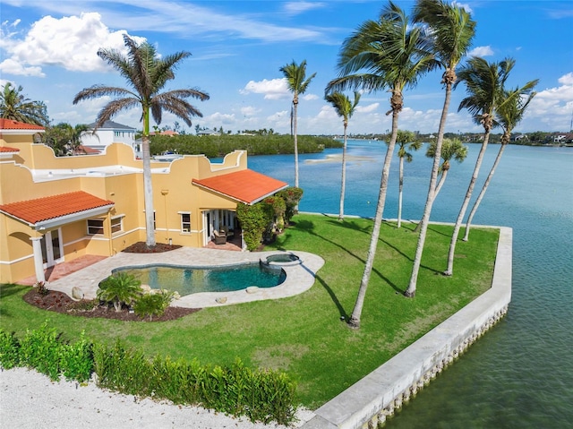 view of swimming pool with a lawn, a water view, and a patio