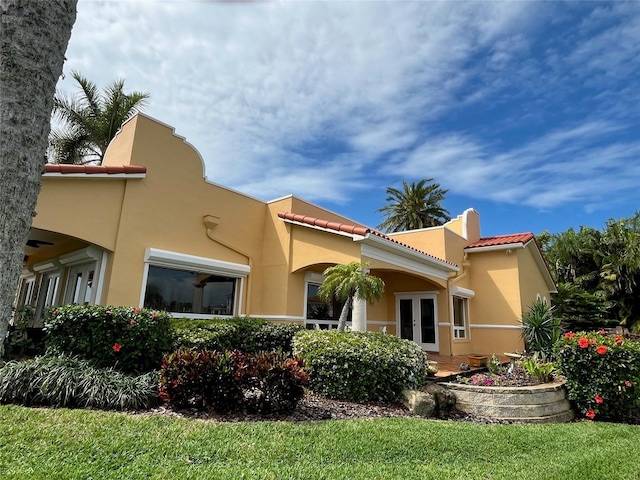 rear view of property featuring french doors