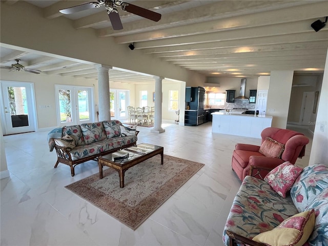 living room featuring ceiling fan, beam ceiling, and decorative columns