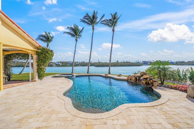 view of swimming pool with a patio area and a water view