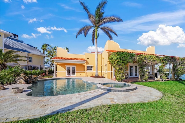 view of pool featuring a lawn, french doors, a patio, and an in ground hot tub