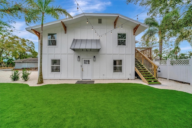 rear view of property with a lawn