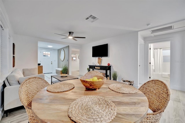 dining space featuring light wood-type flooring and ceiling fan